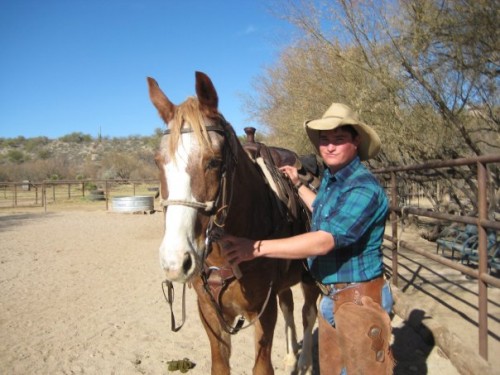 Chris Vassar saddles Mac for a horseback riding vacation