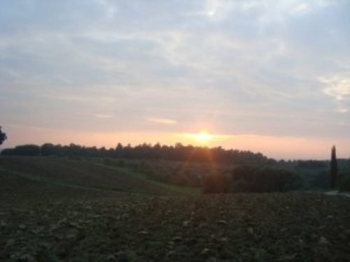 The sun sets in Tuscany after a day of horseback riding in Italy.