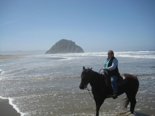 Travel Writer Nancy D. Brown on a horseback riding vacation with Morro Rock in the background