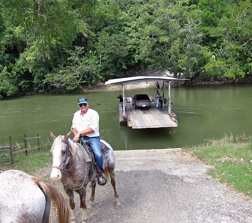 Taking the ferry to upcountry Cayo District of western Belize on a horseback riding vacation