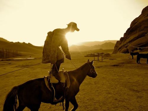 Our 10-year-old tour guide shows off during our horseback riding vacation in Mongolia