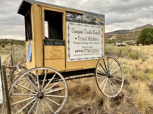 The vintage US Mail wagon holds a sign for Canyon Trails Ranch. Take a Mesa Verde horseback riding vacation at Canyon Trails Ranch in Cortez, Colorado.